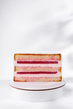Layered sponge cake slice with pink berry jelly 库存照片