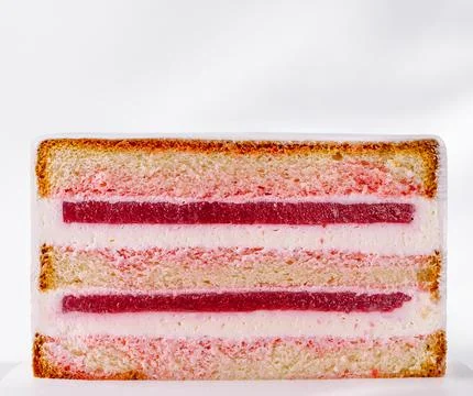 Layered strawberry sponge cake slice with jelly and cream Stock Photos