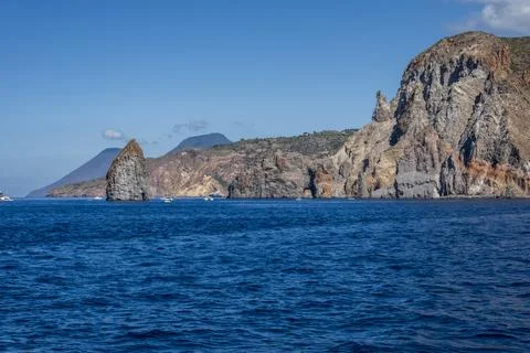 Layered volcanic cliffs, sea stacks and rugged slopes Stock Photos