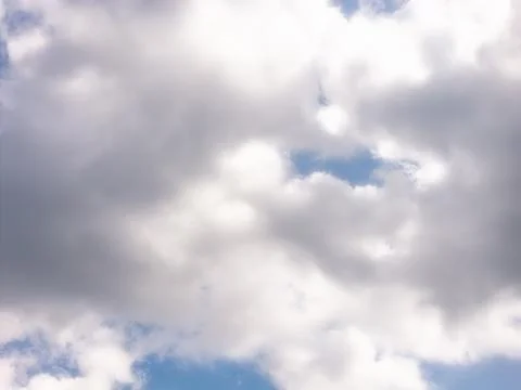Layered White and Gray Clouds With Small Blue Sky Gaps Stock Photos