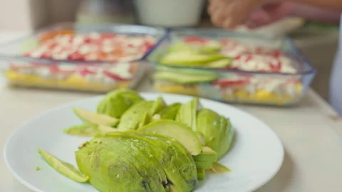 Layering avocato Slices for Peruvian Causa Rellena Preparation Stock Footage 338340931
