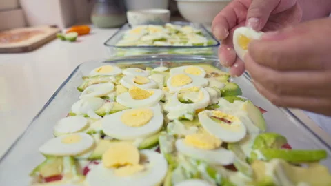 Layering egg Slices for Peruvian Causa Rellena Preparation Stock Footage 338341102
