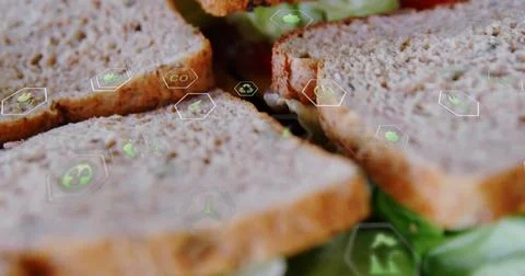 Layering four whole wheat bread slices on green lettuce in kitchen, featuring Stock Photos