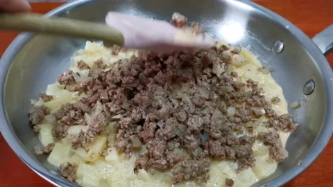 Layering Minced Meat on Top of Diced Potatoes Stock Footage 162879941