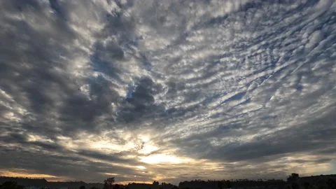 Layers of Clouds in Sky with Rays of Sun Light During an Epic Sunset. Time Lapse Stock Footage
