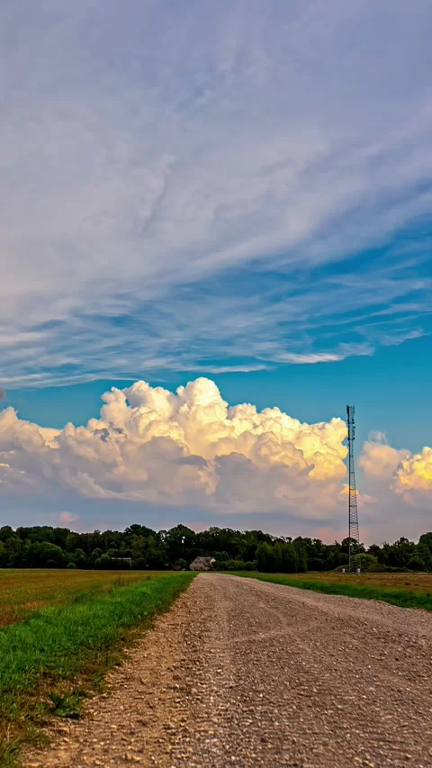 Layers of cumulus clouds moving along bursting in sky looking scenic over a Stock Footage 317625332