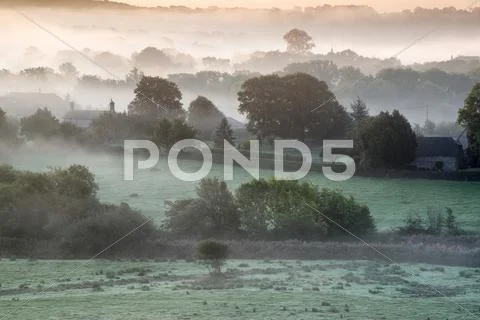 Layers of fog over autumn agricultural landscape Stock Photos