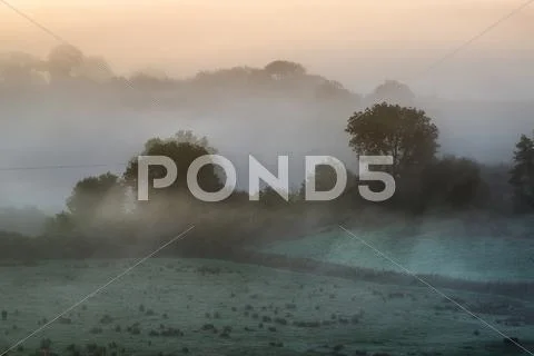 Layers of fog over autumn agricultural landscape Stock Photos