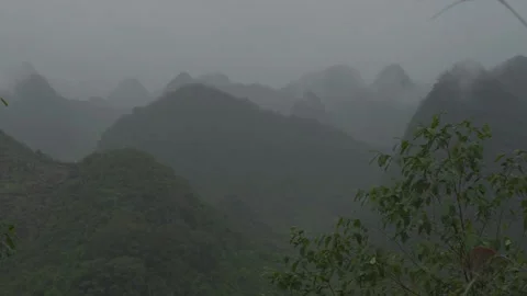 Layers Of Karst Mountains Fading Into Dense Fog During Rainy Weather In Ha Giang Stock Footage 336719413
