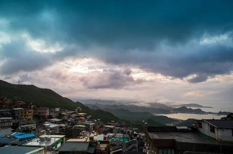 Layers of mountains and layers of clouds and villages combine to form a picture. Stock Photos