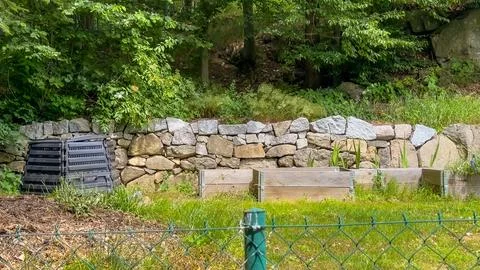 Layers of rotting compost in plastic composter bin in spring garden in village Stock Photos
