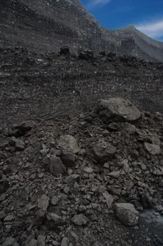 Layers of rough coal in the open pit mine Stock Photos