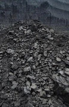 Layers of rough coal in the open pit mine Stock Photos