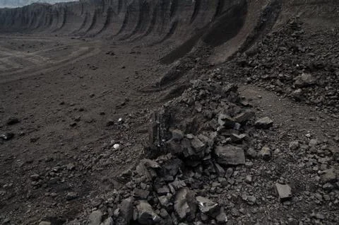Layers of rough coal in the open pit mine Stock Photos