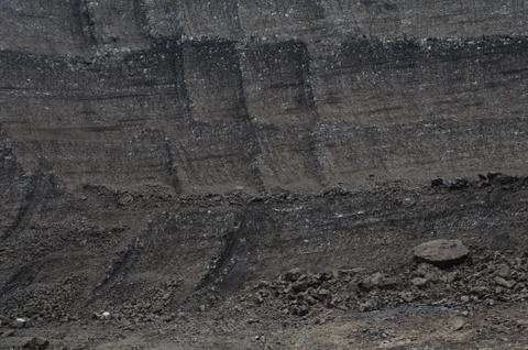 Layers of rough coal in the open pit mine Stock Photos