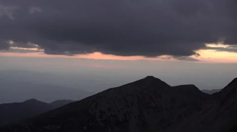 Layers of Sunset Clouds Over Mountain Peaks 4K Stock Footage 67478258