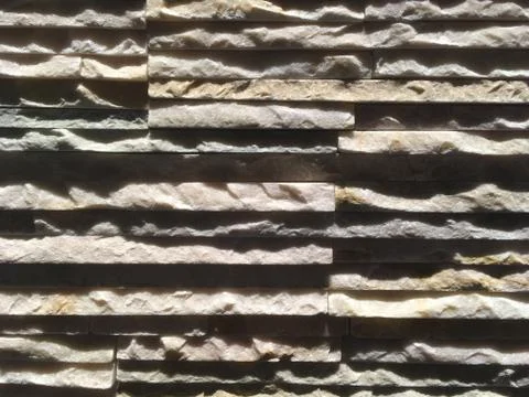 Layers of thin slate rock, uneven and jagged. Interior wall of granite of dif Stock Photos