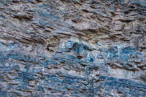 Layers of various limestone rocks visible in the exposed mountainside Stock Photos