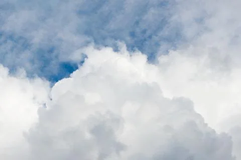 Layers of white clouds against the clear blue sky on a sunny day Stock Photos