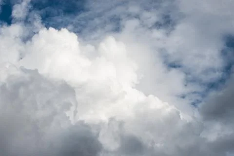 Layers of white fluffy clouds against the blue sky Stock Photos