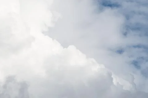 Layers of white fluffy clouds against the blue sky Stock Photos