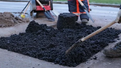 Laying Asphalt In A Pothole Stock Footage