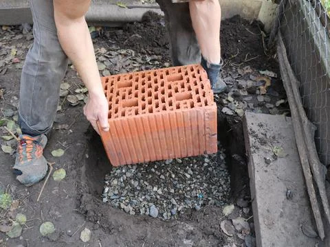 Laying the block in a pit under the foundation Stock Photos