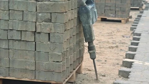 Laying bricks at a construction site, balancing material on pallets. The area is Stock Footage 344675449