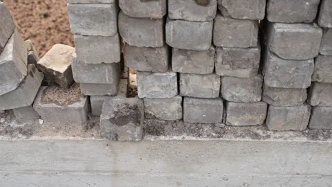 Laying bricks under the foundation of a house Stock Footage 276258362