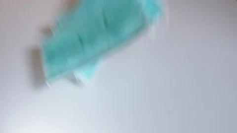 Laying a bunch of face masks on table [6K30] Stock-Footage 127324830