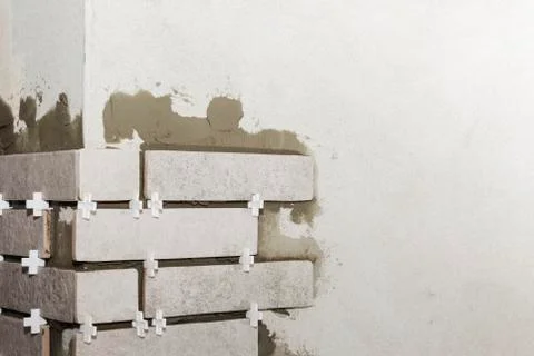 Laying Ceramic Tiles. The Builder makes repairs. Stock Photos