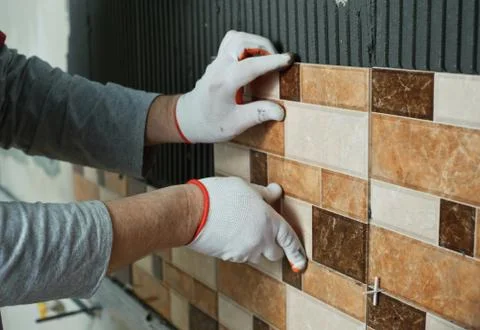 Laying Ceramic Tiles. Stock Photos