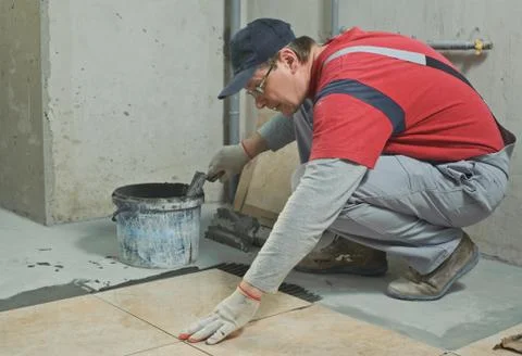 Laying Ceramic Tiles. Stock Photos