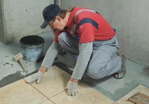 Laying Ceramic Tiles. Stock Photos