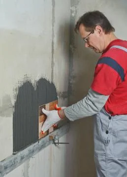 Laying Ceramic Tiles. Stock Photos
