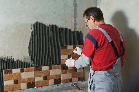 Laying Ceramic Tiles. Stock Photos