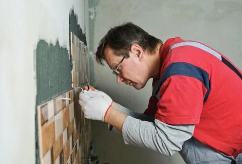 Laying Ceramic Tiles. Stock Photos