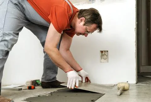Laying Ceramic Tiles. Stock Photos