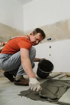 Laying Ceramic Tiles. Stock Photos