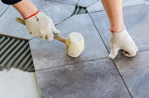 Laying Ceramic Tiles. Stock Photos