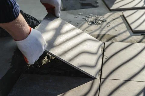 Laying Ceramic Tiles. Stock Photos