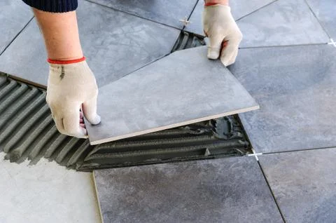 Laying Ceramic Tiles. Stock Photos