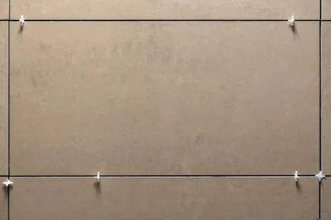 Laying ceramic tiles using plastic crosses. Use plastic crosses to align the  Stock Photos