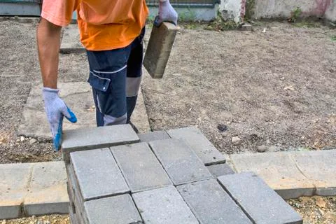 Laying concrete bricks for the sidewalk Stock Photos