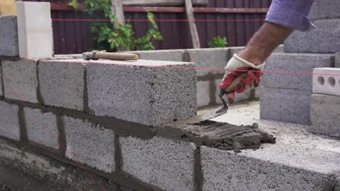Laying Concrete Cinder Blocks for a Wall Construction Stock Footage 314308979
