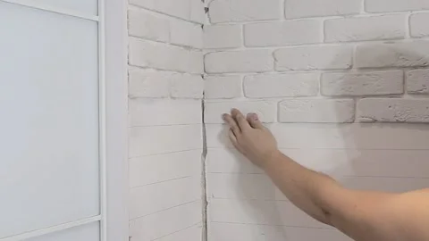 Laying decorative embossed gypsum bricks on the wall. Modern apartment Video stock 218617214