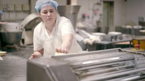 Laying the dough on the conveyor Stock Footage 76873769