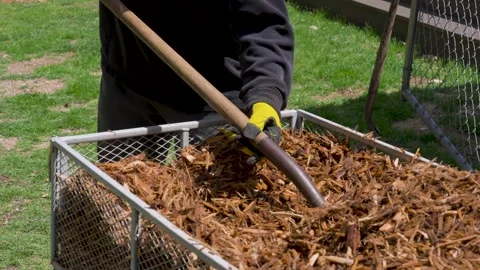 Laying down fresh Mulch for the Summer season. Stock Footage 336583682