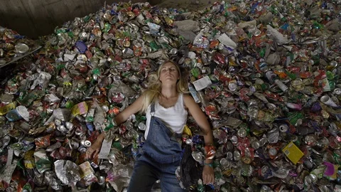 Laying down - Nature pollution activist at a huge trash dump - Young blonde Stock-Footage 120805281