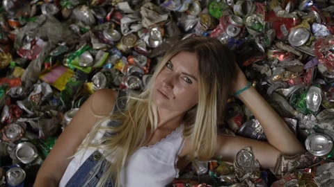 Laying down - Nature pollution activist at a huge trash dump - Young blonde Stock-Footage 120805294